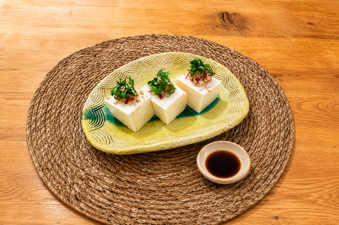 Chilled tofu served with Japanese soy sauce and fresh garnishes