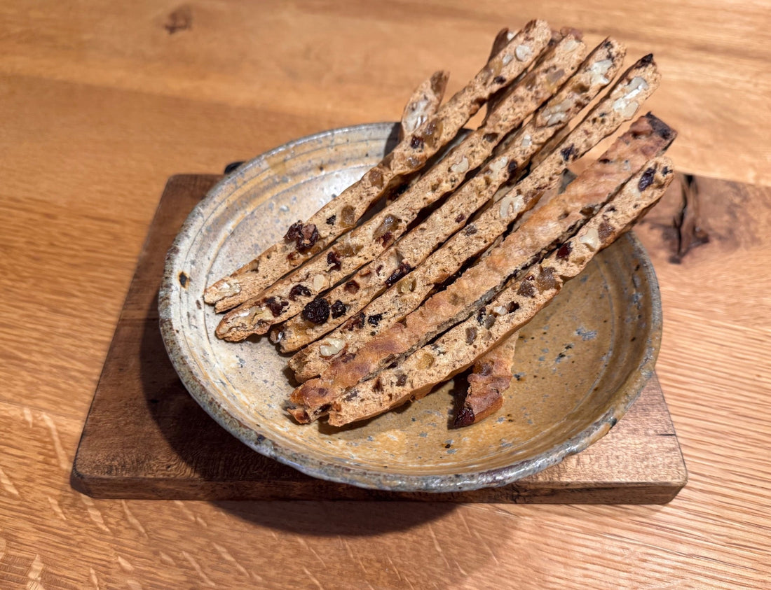 Sliced hamanatto and mixed nut biscotti sticks on a plate