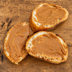 Slices of bread spread with kinako butter on a wooden board