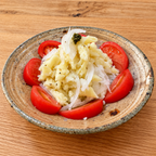 Potato salad with sliced onion and tomatoes, topped with a dab of shiso kosho