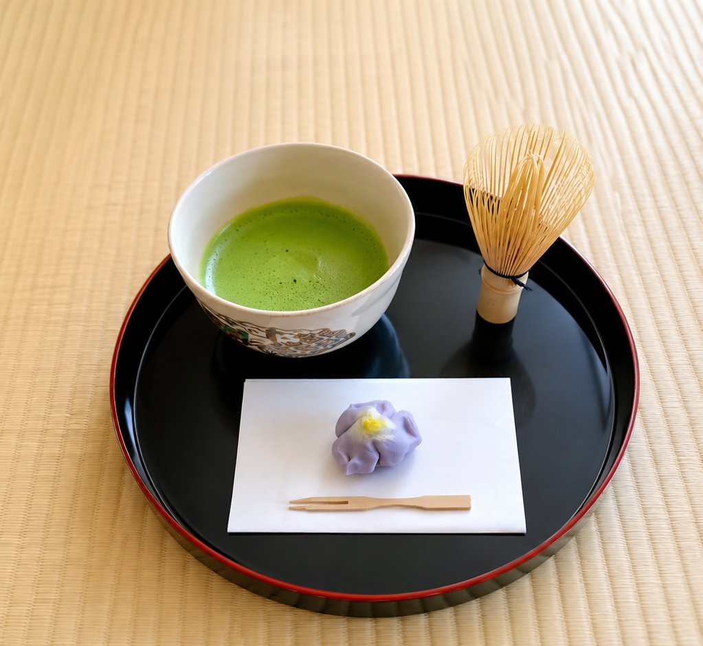Green matcha tea with wagashi sweet on a tray