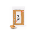 A 100g bag of Kyo Kinako Kurosu roasted soybean flour from Kitao in Kyoto, with a small dish of kinako in front