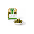 Jar of shiso kosho (Obagoshou) beside a small dish of the green paste